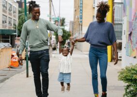 A family of three having a happy time with their daughter