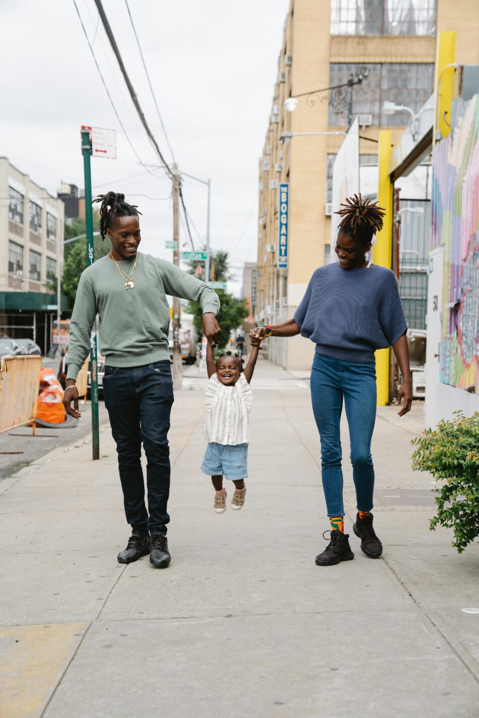 A family of three having a happy time with their daughter